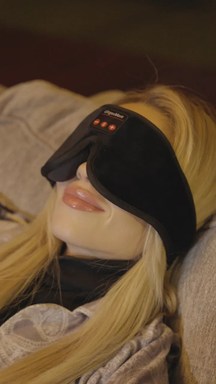 Close profile of a woman wearing the mask, lying down in warm light